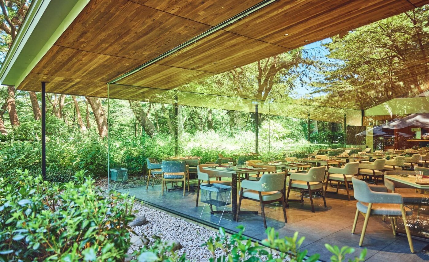 Glass-walled dining space at the Teien Art Museum, open to the wooded garden