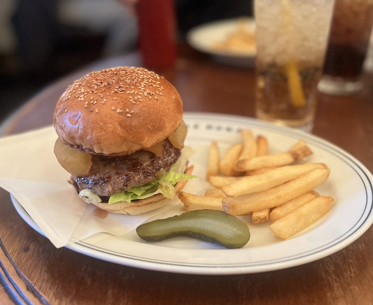 FIRE HOUSE Hongo burger with fries and a pickle on a branded plate